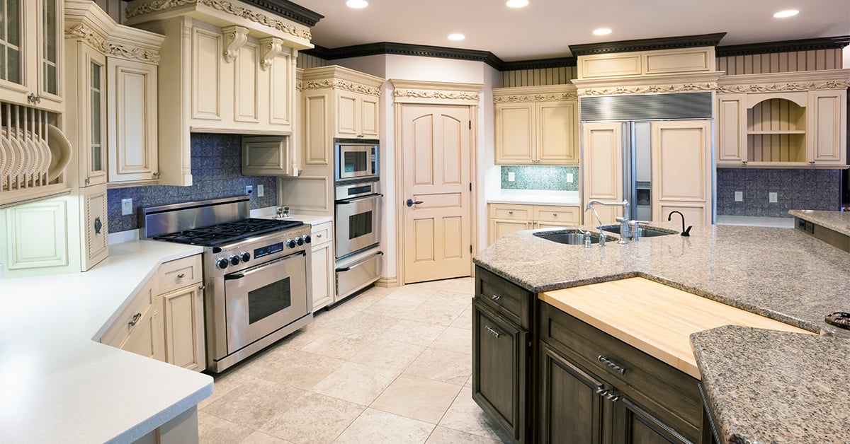 Enormous, brand new remodeled kitchen with off white woodwork.