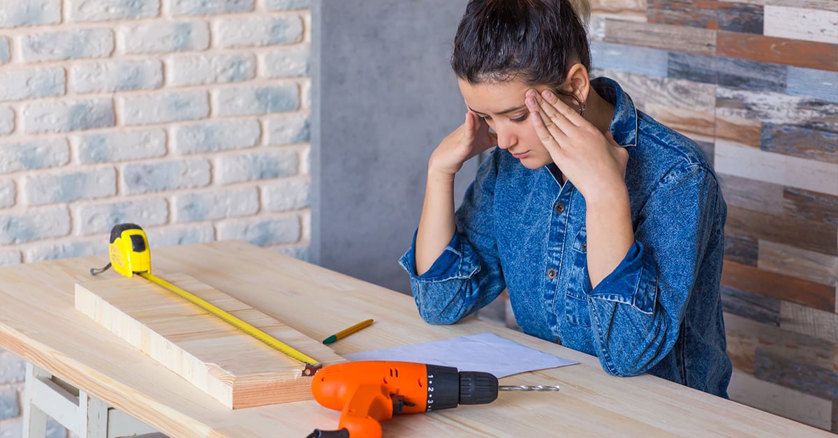 Woman rubbing her head in confusion during a remodel