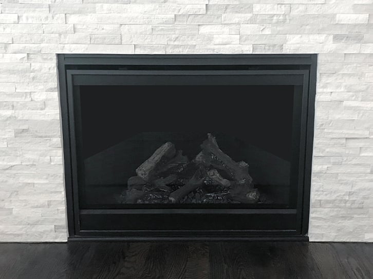 A classy fireplace with white, brick style tile surround