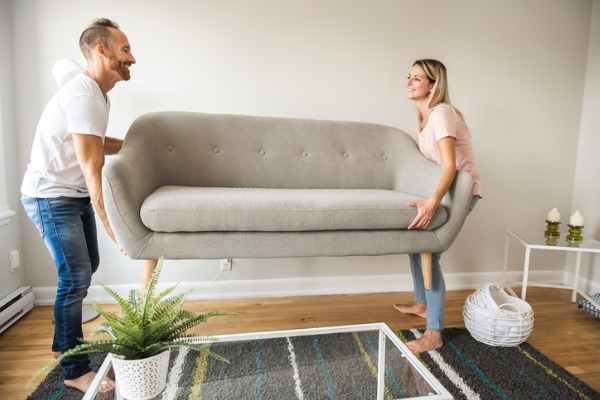 couple rearranging couch